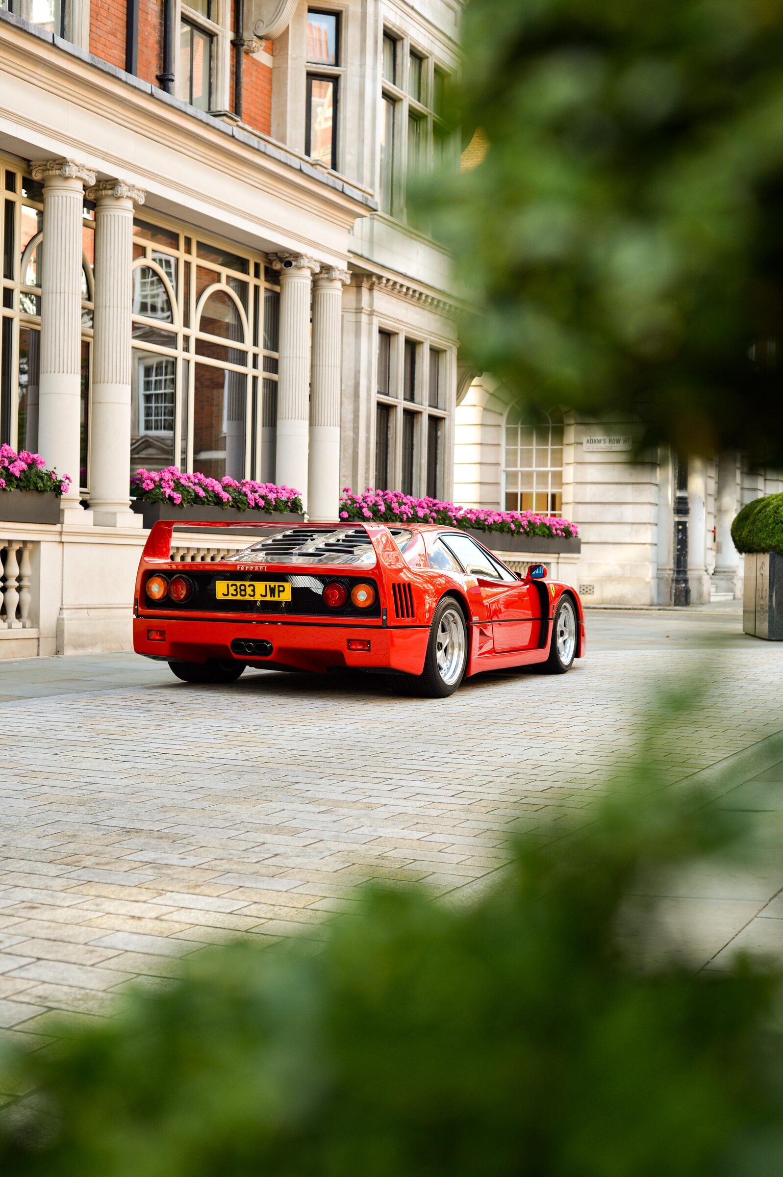 Red Ferrari F40 parked outside a London building