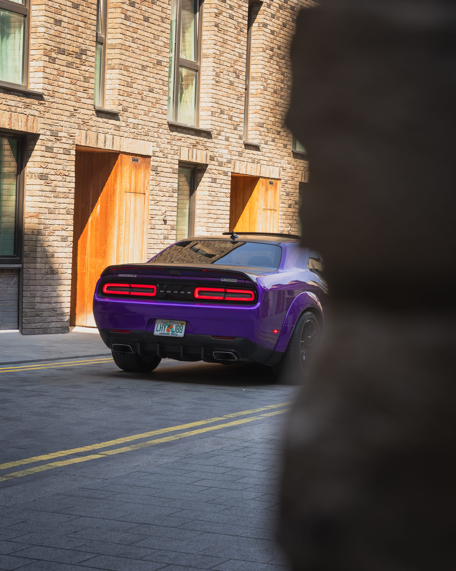 Purple Dodge Challenger rear shot in an alleyway